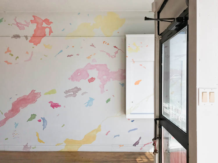 lake ramsey figures in bright pink in colette laliberte exhibition at the galeire du nouvel ontario